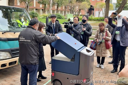 メディアに囲まれながら、お弁当を取り出す特異な光景。